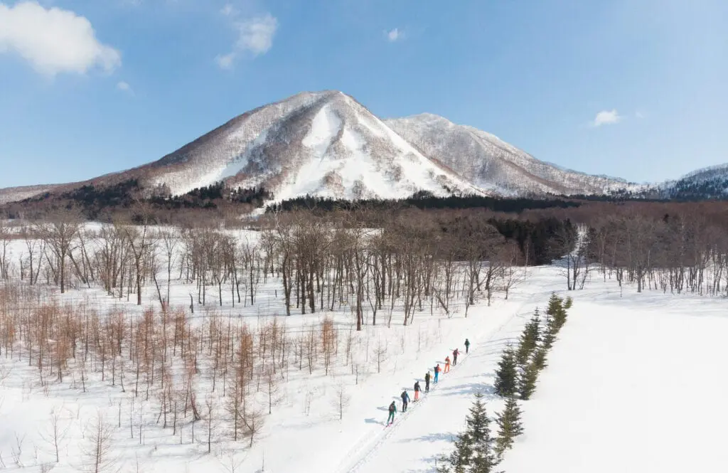 Mountains in Japan with skiers making the climb up.