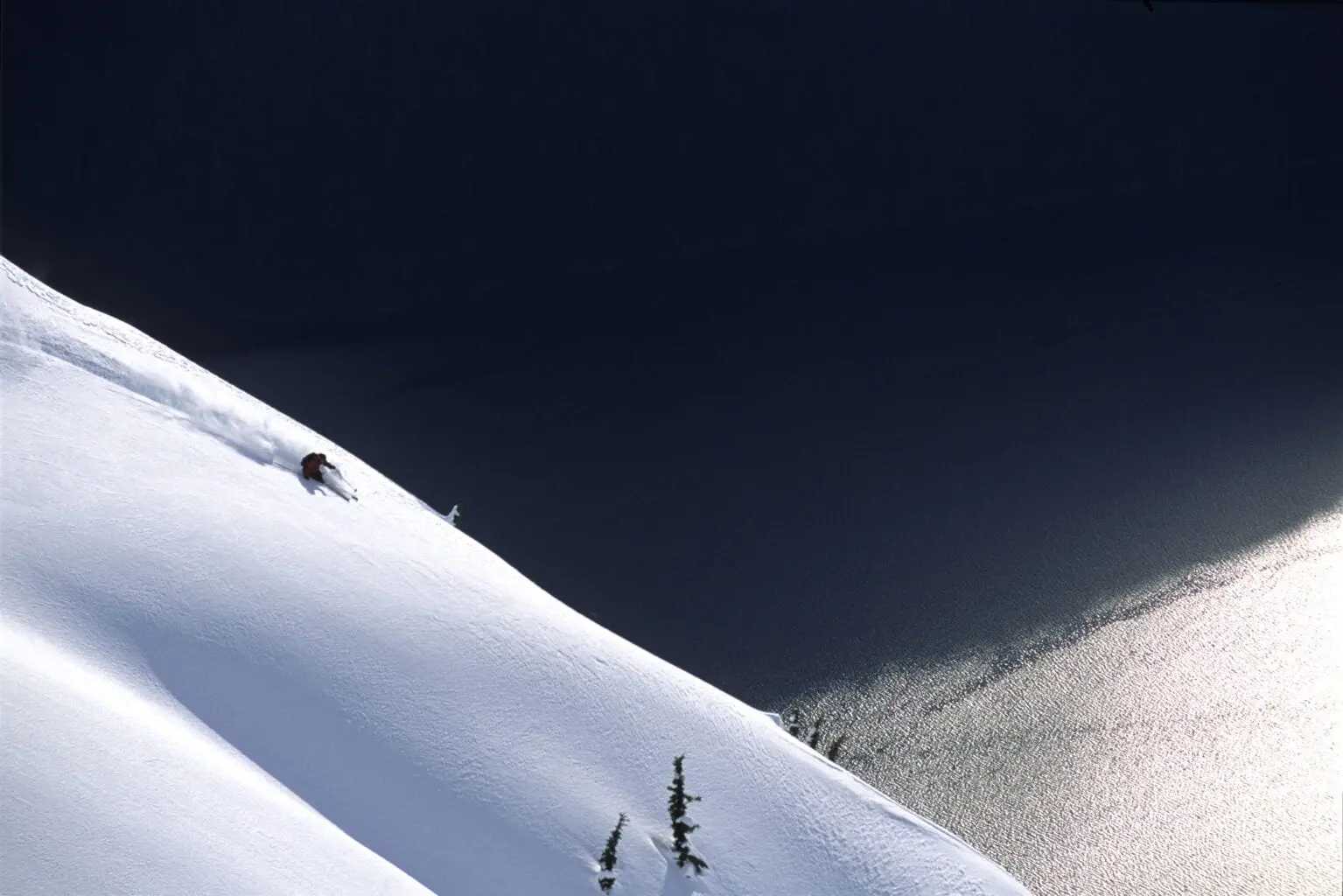 Mabey Ski Catamaran Skiing Trip descending mountain in front of see