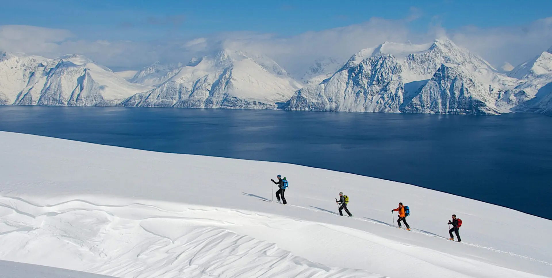 4 skiers ascending Lyngen Alps in Norway